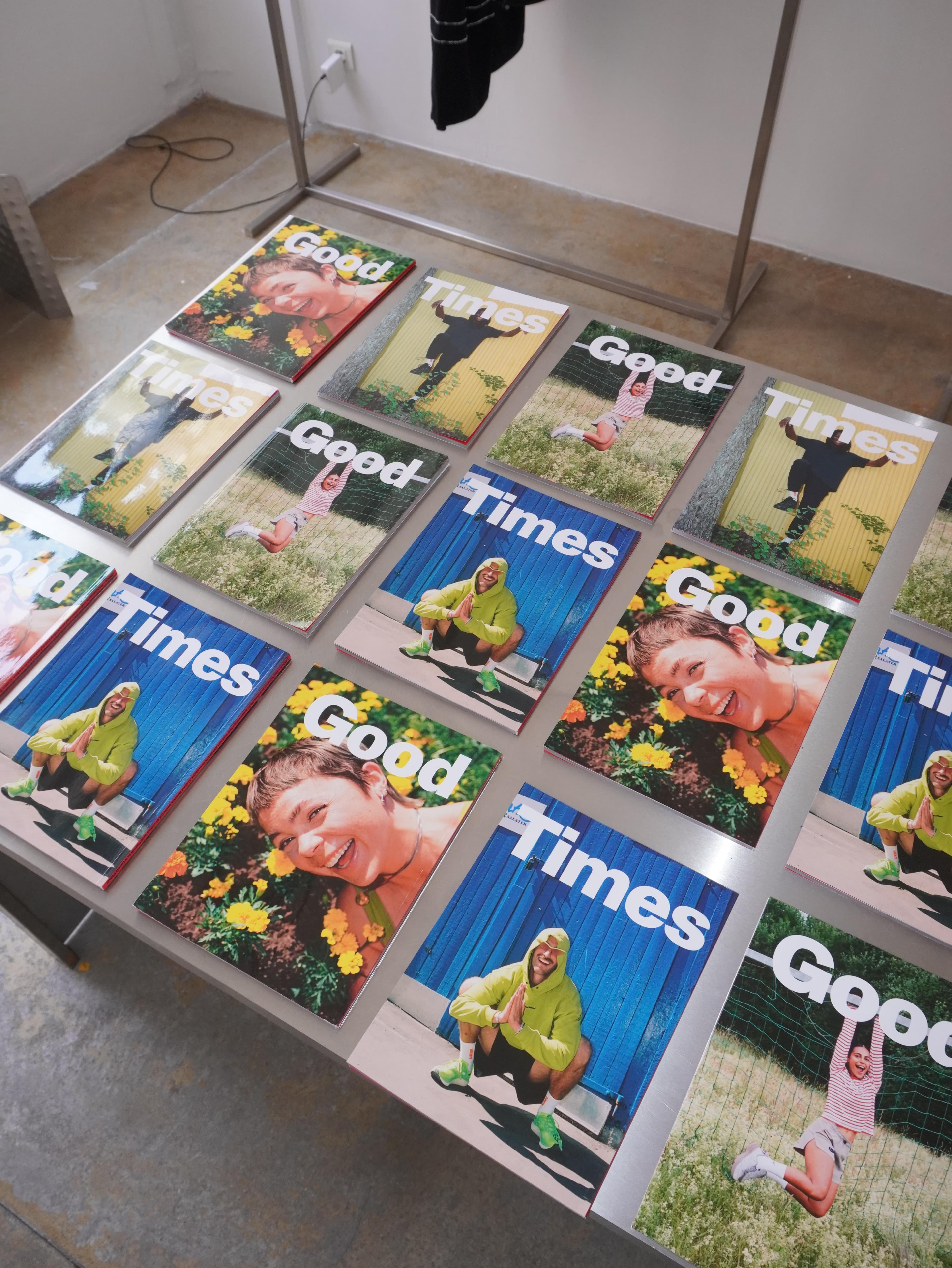 Multiple copies of "Good" and "Times" magazines with varied covers featuring people in different outdoor settings.